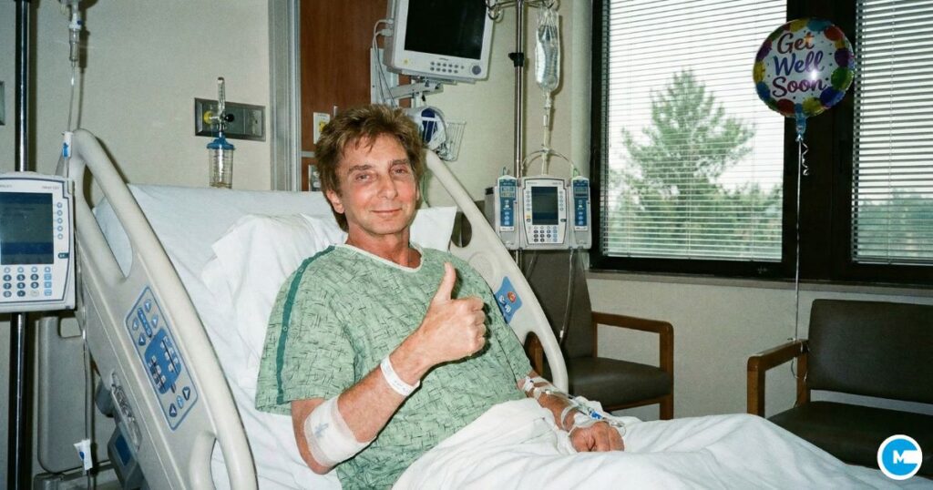 Singer Barry Manilow smiling in hospital bed wearing green hospital gown, giving thumbs up or positive gesture, recovering post-surgery, medical setting, optimistic recovery photo