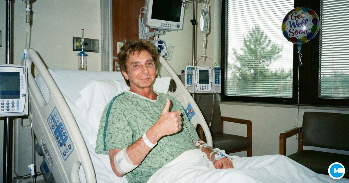 Singer Barry Manilow smiling in hospital bed wearing green hospital gown, giving thumbs up or positive gesture, recovering post-surgery, medical setting, optimistic recovery photo